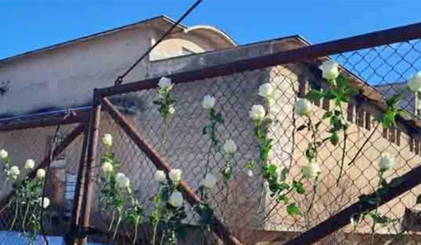SEVERAL FORMER CAMP INMATES LAID FLOWERS AT GATES OF "SILOS" CAMP