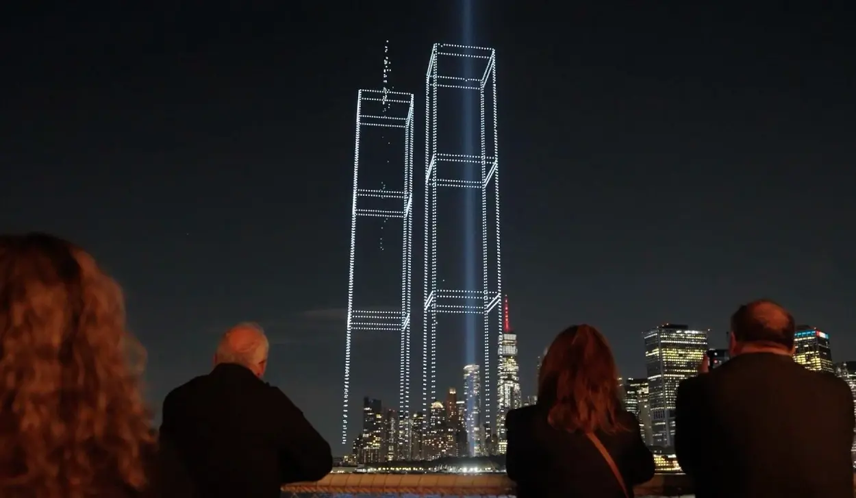 DRONES LIGHT UP THE PORT AND REVEAL OUTLINES OF TOWERS