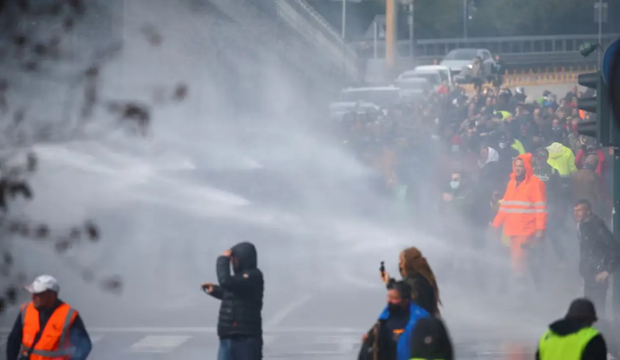 POLICE TRY TO DISPERSE DEMONSTRATORS WITH WATER CANNON